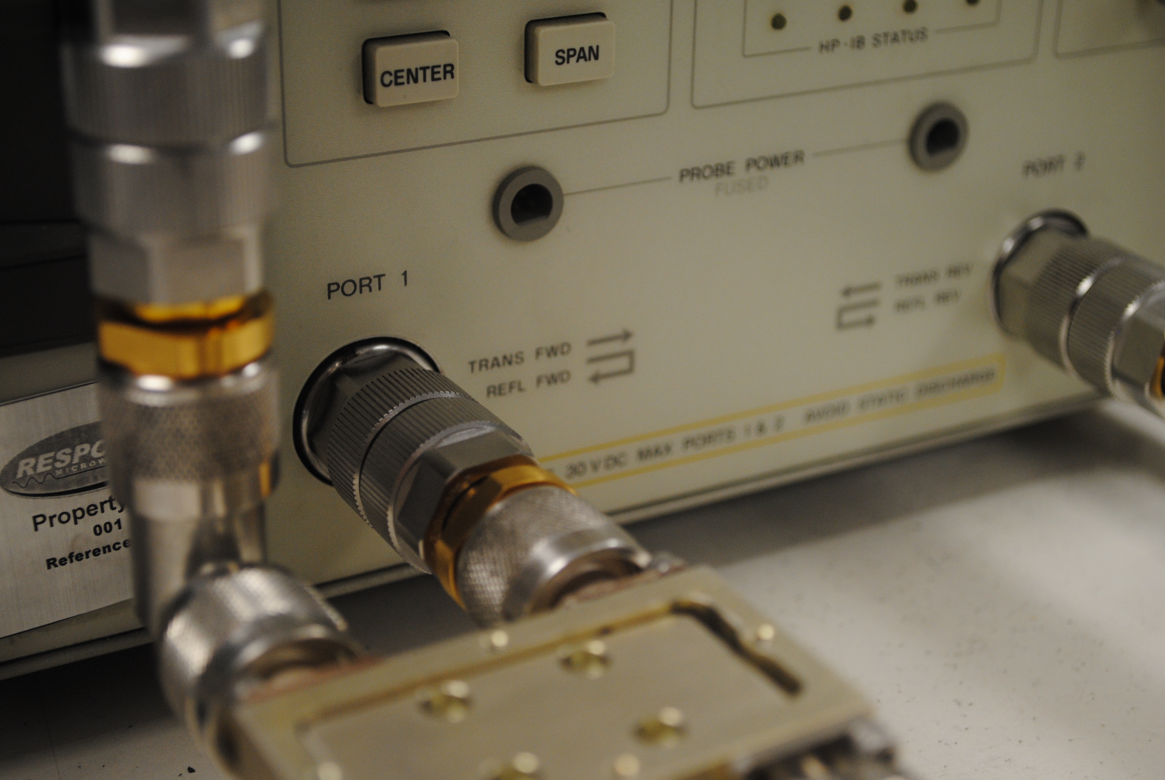 RF measurement bench with precision coaxial connectors at PORT 1 and PORT 2 of a network analyzer